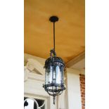 A wrought metal hanging lantern, in 18th century style, of four lights,