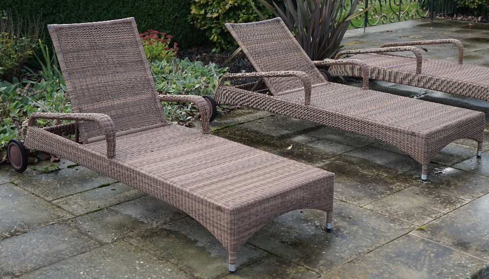 Expormim; a pair of pool side reclining loungers with loose green cushions.