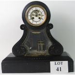 A 19th century marble cased striking mantel clock with incised decoration and metal mounts,