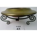 An Arts & Crafts copper bowl raised on a wrought iron stand, 38cm diameter,