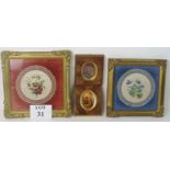 A matched pair of foliate painted silk and lace doilies displayed within ornate gilt frames,