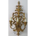 An ornate vintage/antique carved giltwood three-branch wall light, 61cm high,