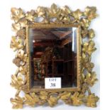 An ornate and decorative carved giltwood framed bevelled wall mirror in the 19th century taste,