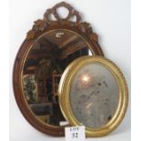 An oval fruitwood framed wall mirror with ribbon surmount, and an oval gilt framed wall mirror,