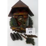 A vintage Black Forest cuckoo clock with moving waterwheel, with weights and pendulum,