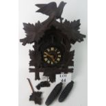 A vintage Black Forest cuckoo clock, typical carved wooden case, twin pine-cone weights,