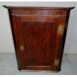 A 19th century oak corner cupboard with