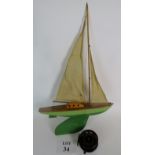 A wooden pond yacht and a bakelite fishi