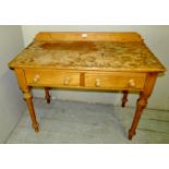 A Victorian pine writing table with two