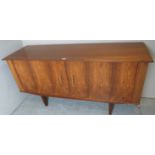 A 1960's/70's teak and rosewood sideboard with double rosewood doors and a fitted interior of