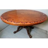 A Victorian inlaid walnut tilt top loo table with ornate carved base, c1890,