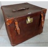 An early 20th century square storage trunk with leather handles and corners and original brass lock,