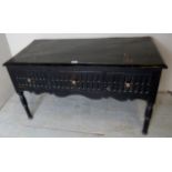 An early 20th century ebonised low side table with three frieze drawers,