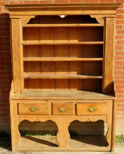 A super 19th century pine dresser with open plate rack with boarded back,