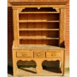 A super 19th century pine dresser with open plate rack with boarded back,