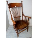 A 19th century American oak stickback fireside amchair, in good condition, c1900,