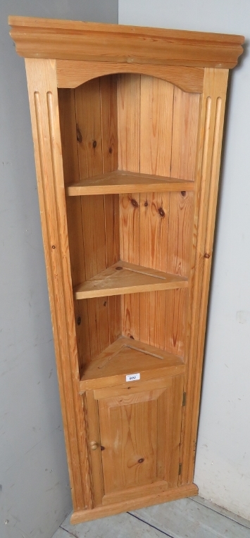A modern slim pine freestanding corner cupboard,