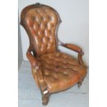 A Victorian gentlemans walnut spoonback leather armchair with a deep buttoned tan leather