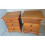 A pair of contemporary oak bedside cupboards, each with 3 drawers and turned handles,