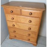 A contemporary pale oak chest of 2 short over 3 long drawers with turned handles, good quality,