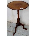 An Edwardian mahogany tripod wine table with carved column,