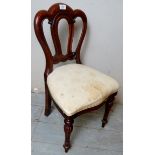 A Victorian design mahogany child's chair upholstered in cream material,