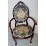 An Edwardian mahogany elbow chair with oval tapestry upholstered back and seat,