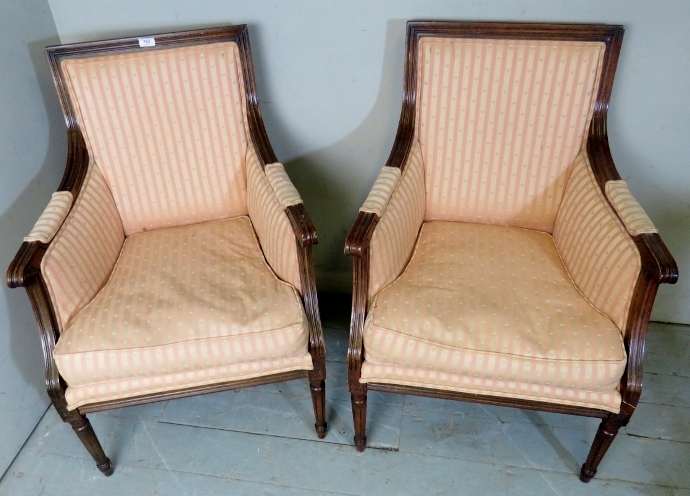 A pair of Regency style library chairs upholstered in a pink stripe material,