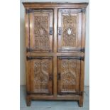 A rare Gothic oak four door cupboard with carved Gothic tracery panels,