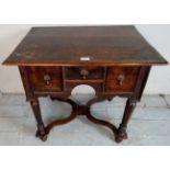 An early/mid 18th century oak lowboy, with three drawers, each with brass drop handles,