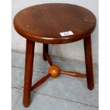 A 20th century Arts & Crafts tripod stool with unusual centre ball stretcher,