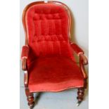 A Victorian mahogany framed open gentlemans armchair upholstered in deep buttoned pink material,