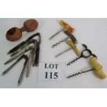 Two antique corkscrews and three others,