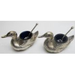 A pair of silver salts in the shape of a