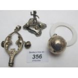 A silver bell rattle and teething ring,