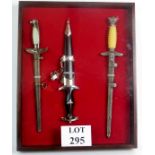 Three reproduction German daggers framed