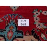 A mid 20th century Persian rug on claret