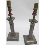 A pair of silver candlesticks decorated