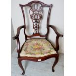 An Art Nouveau mahogany elbow chair upho