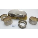Four silver napkin rings and a silver ba