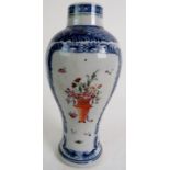 A 19th century Chinese export vase with blue and white border and a central polychrome floral spray,
