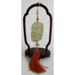 A finely carved and pierced Chinese Jade pendant on a sash with bead and tassel,
