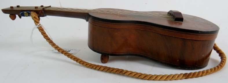 A Spanish guitar with inlaid decoration, early 20th century, fitted with a musical box, hinged lid,