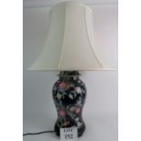 A modern enamel decorated ceramic table lamp in the form of a Chinese temple jar, with shade.