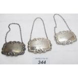 Three silver decanter labels with shell decoration, (whisky and two sherry).