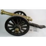 A decorative cast iron and bronze model of a cannon, total length 76cm, length of barrel 49cm,