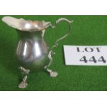 A small silver jug, hallmarked London 1967/8, weighs 109 grams,