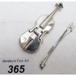 A miniature violin and bow, marked 925.