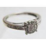 A 9ct white gold diamond set ring comprising of 4 centre diamonds,