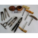 Two antique corkscrews and three others, plus five nut crackers,